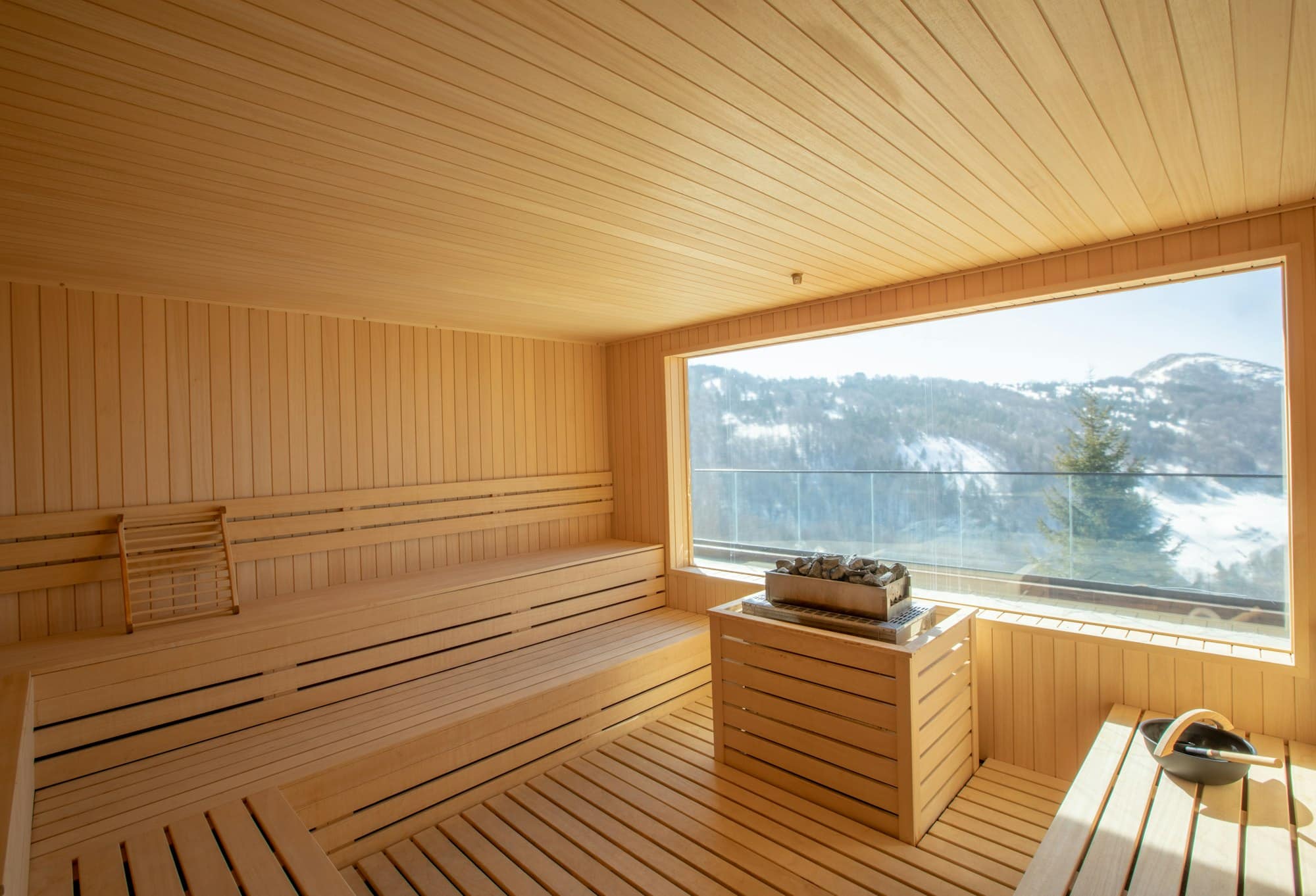 Empty wooden sauna room with traditional sauna accessories