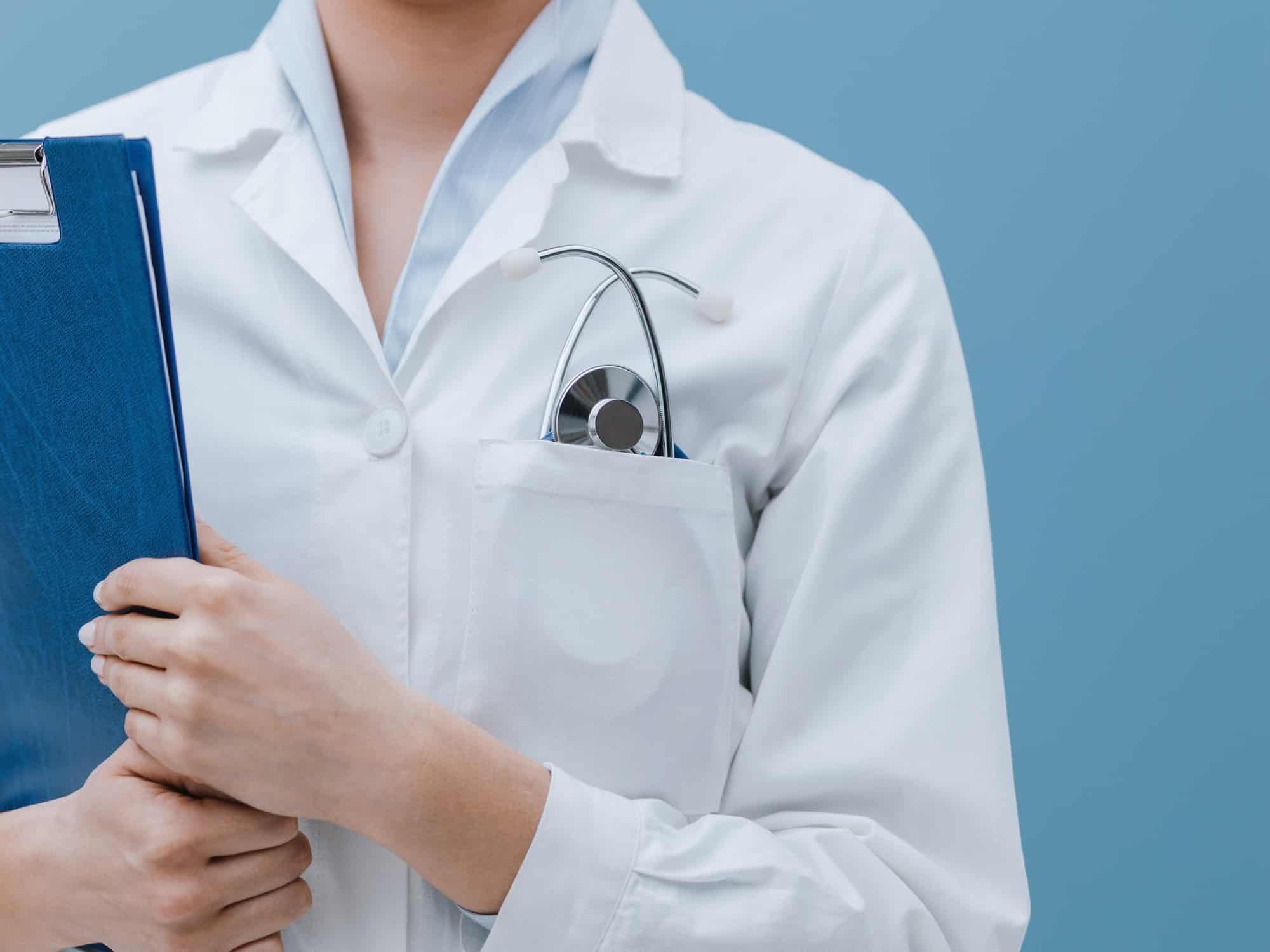 Professional female doctor posing with a clipboard