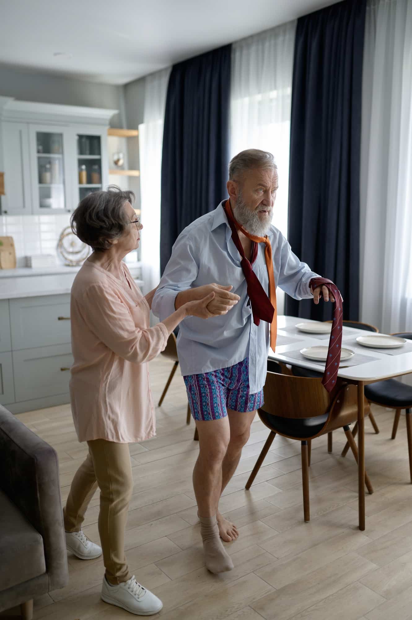 Aged wife caring for her old husband suffering from dementia